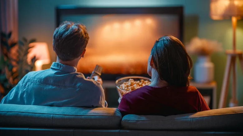 Couple watching TV on couch