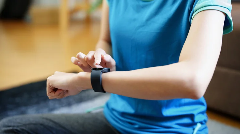 A woman interacting with a smart watch