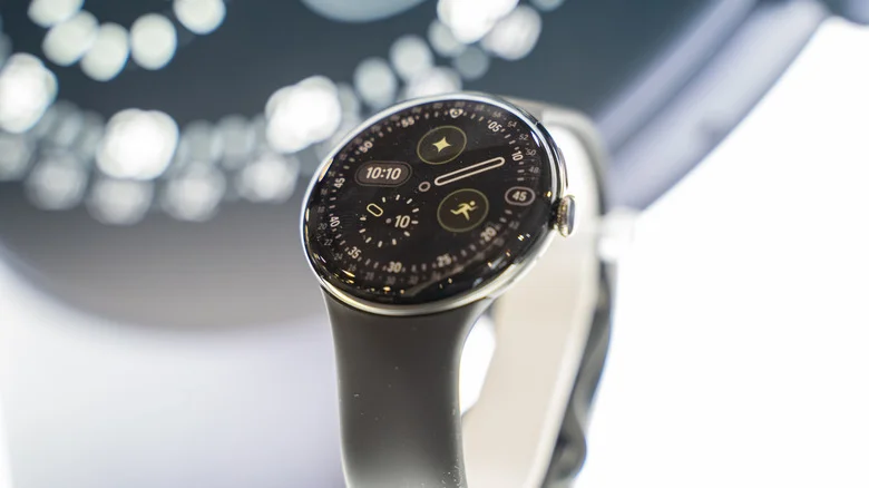 The Google Pixel Watch 4 in front of a display