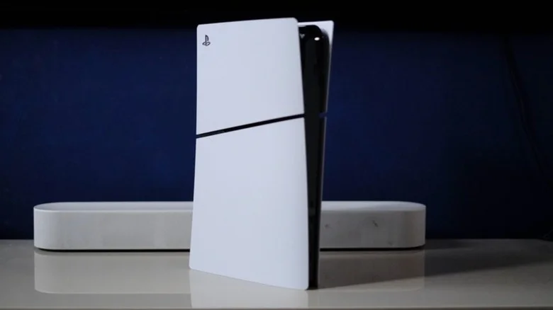 A PS5 with a soundbar against a dark blue background