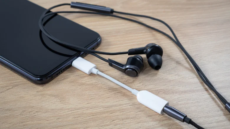 iPhone with a 3.5mm adapter connected