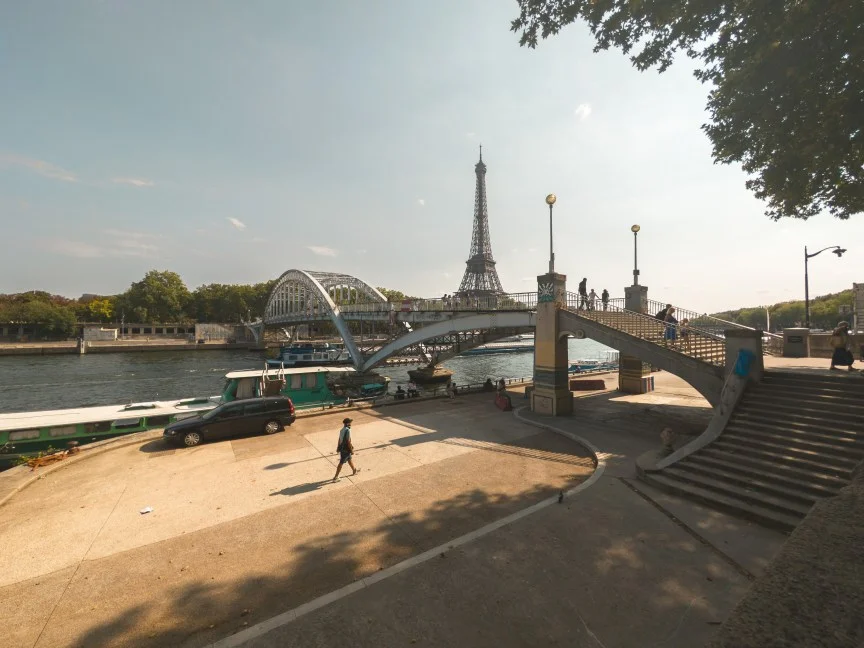 Image of a man walking next to a bridge