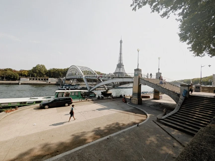Image of a man walking next to a bridge