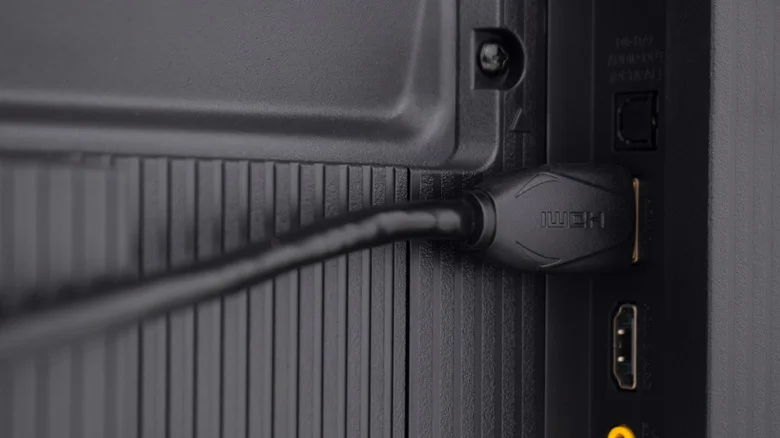 An HDMI cabled plugged into the back of a TV.