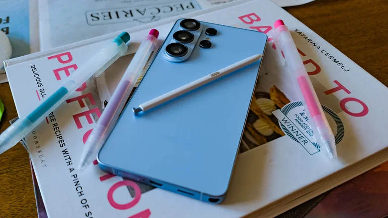 Samsung Galaxy S26 Ultra posed with book and pens