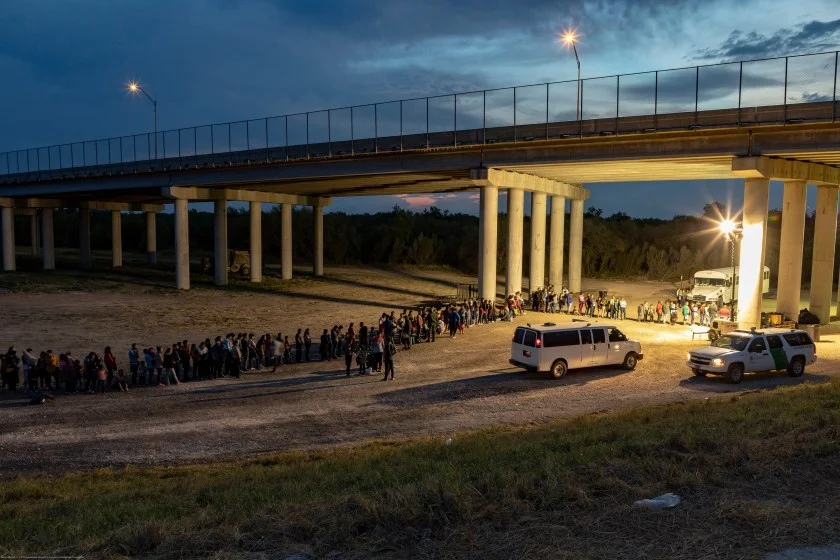 As the sun sets near McAllen TX, migrants that have crossed the Rio Grande surrender to U.S. Border Patrol near an area known as Rincon.