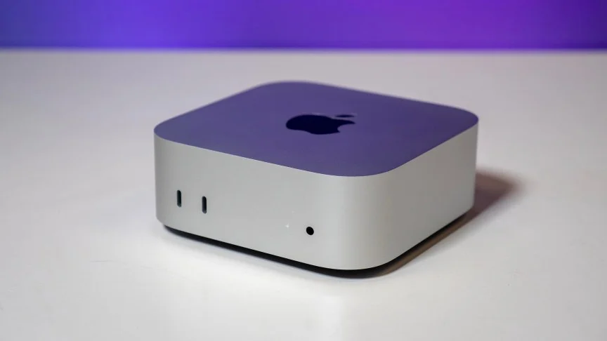 An Apple Mac mini on a white table.