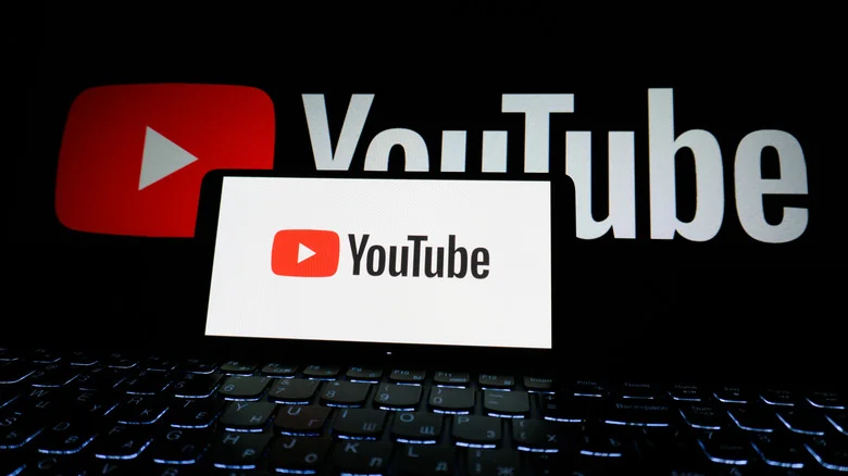 YouTube logo displayed on a phone and a monitor.