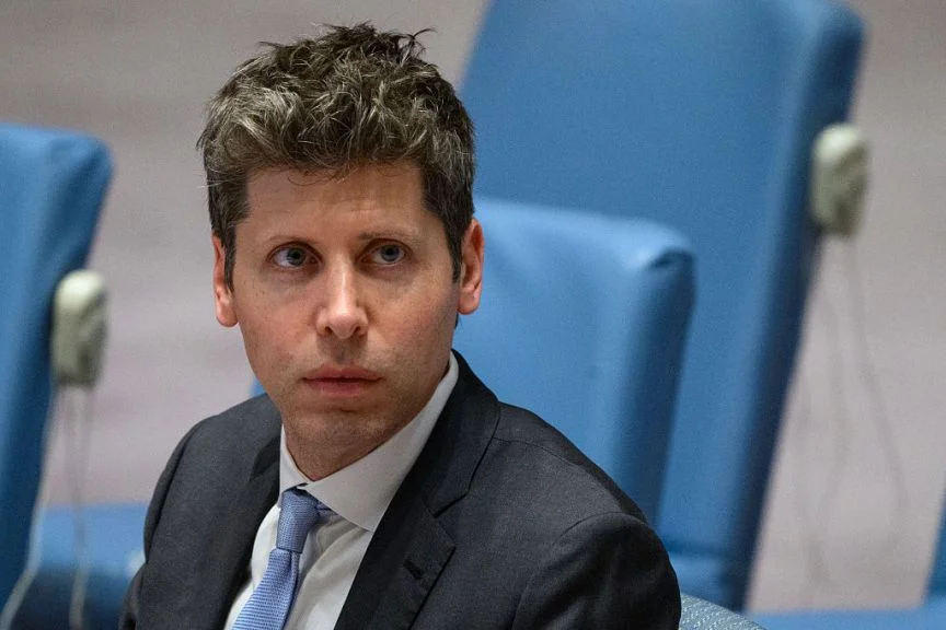 OpenAI CEO Sam Altman sits at the United Nations Security Council. He looks at the camera and there's a sort of menacing affect to him.