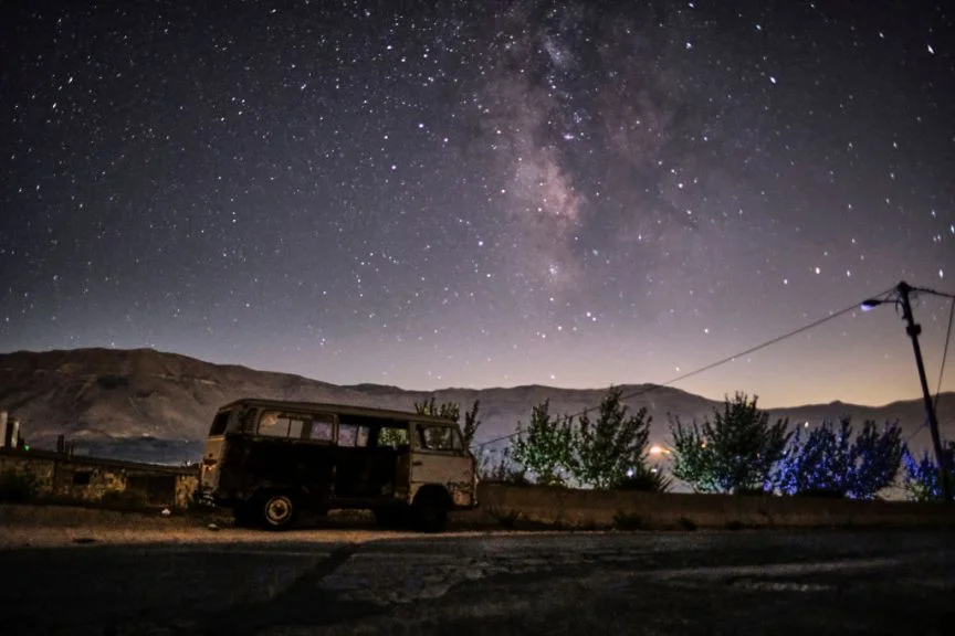Milky Way galaxy in the sky above a derelict van