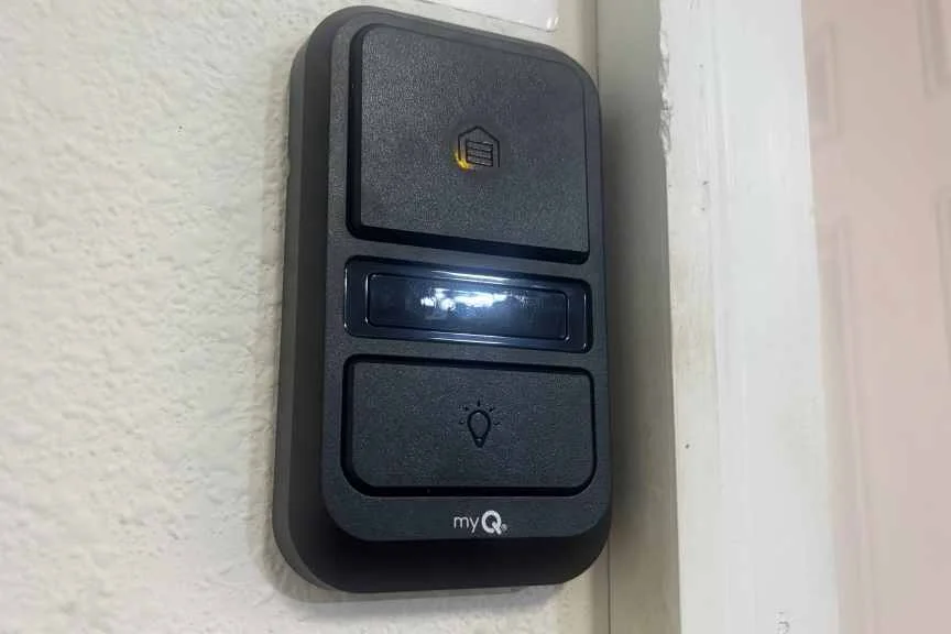 Chamberlain wall mounted garage controller on drywall.